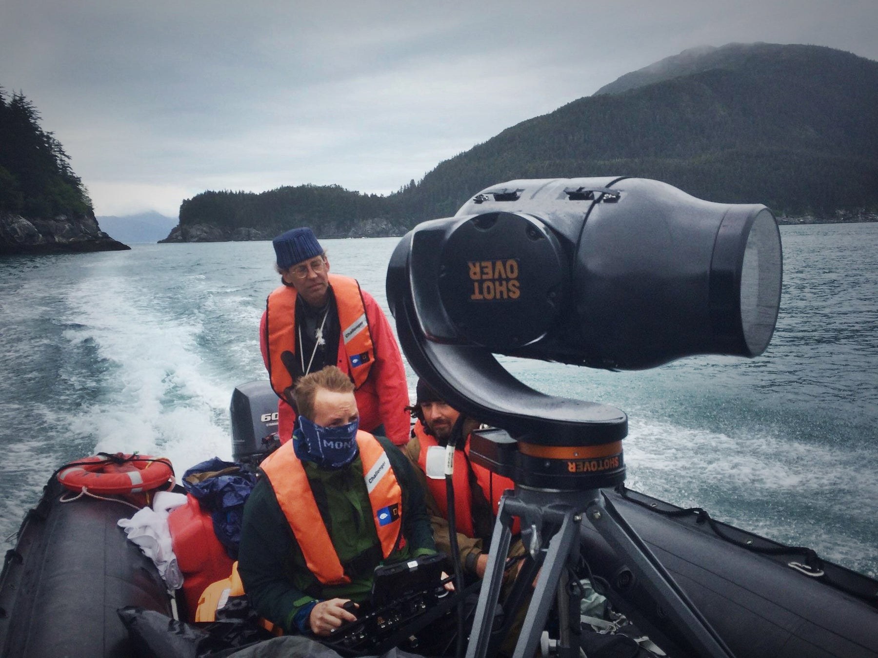 A documentary camera crew on a small boat